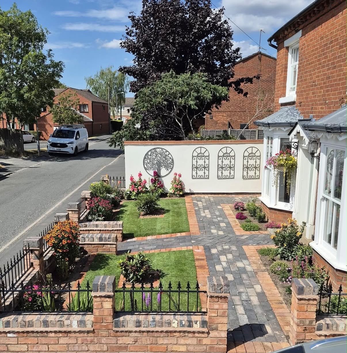 Landscaped front garden with lawns, paths and planting