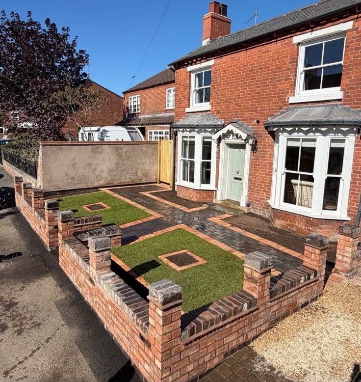 Block paved front garden with brick walls and lawn