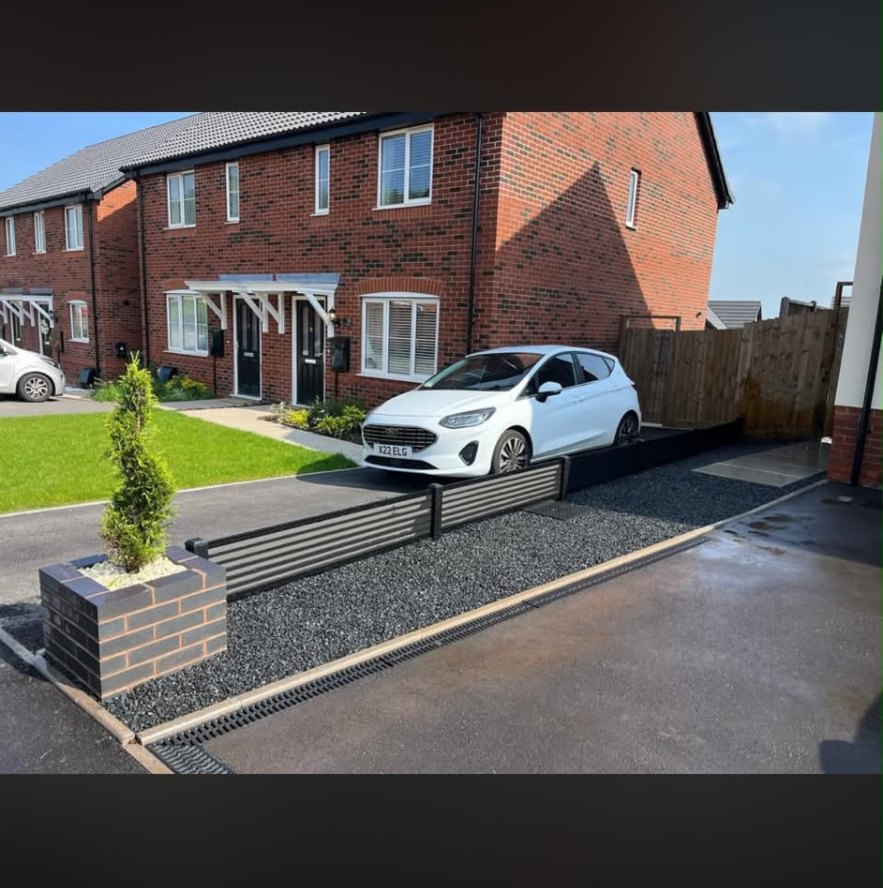 New driveway with drainage channel and gravel border