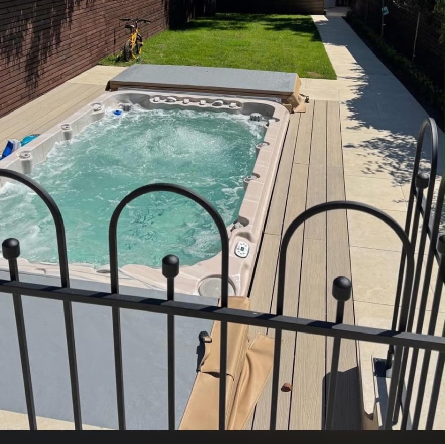 Swim spa set into composite decking with lawn behind