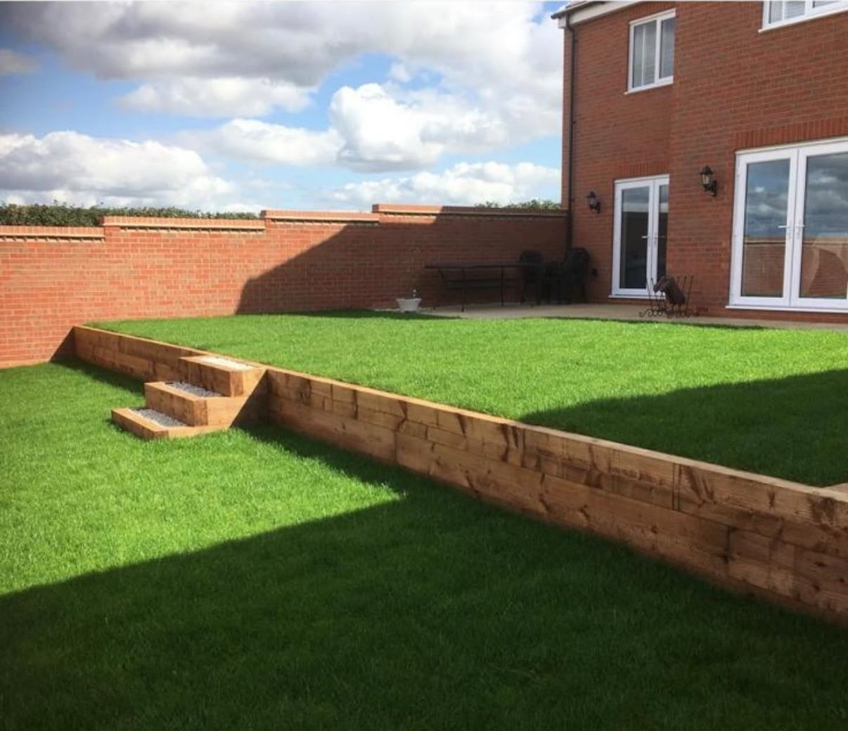 New lawn with sleeper retaining wall and steps